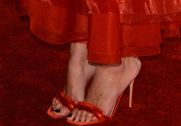 Katie Holmes displays her toes in red Gianvito Rossi sandals with fringe trim