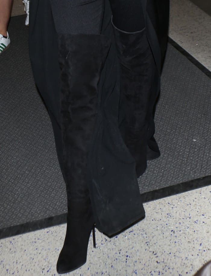Khloe Kardashian in black boots at Los Angeles International Airport