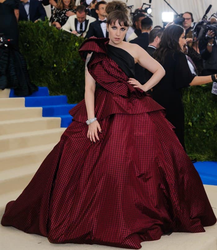 Lena Dunham wearing a custom Elizabeth Kennedy gown and Jeffrey Campbell lace-up boots at the 2017 Met Gala