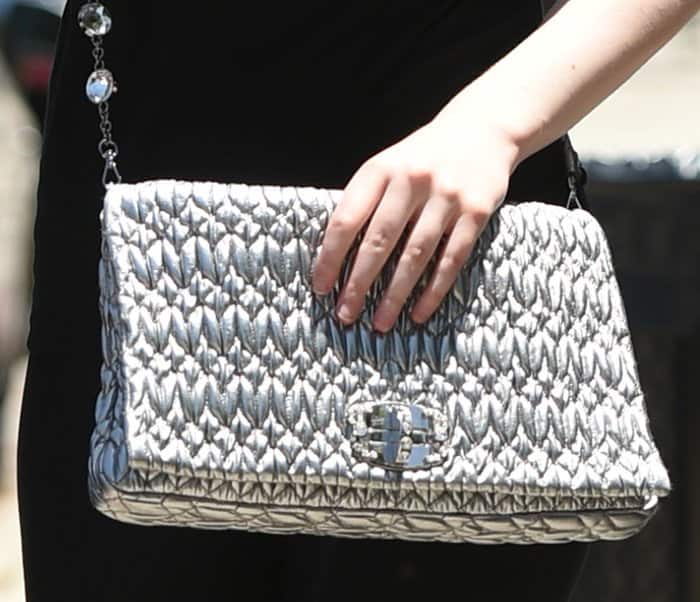Elle Fanning's Miu Miu bag features gorgeous ruching on its leather and a crystal-embellished turnlock