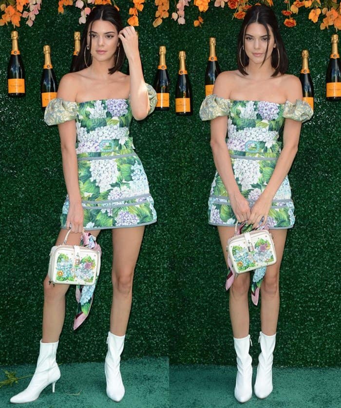 Kendall Jenner stunned in a Dolce & Gabbana off-the-shoulder hydrangea-print mini dress paired with white ankle booties and a floral-embellished box bag for a fresh, spring-ready look