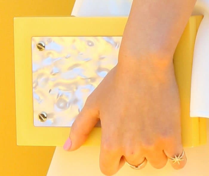 Miranda went matchy-matchy with a yellow Thale Blanc clutch