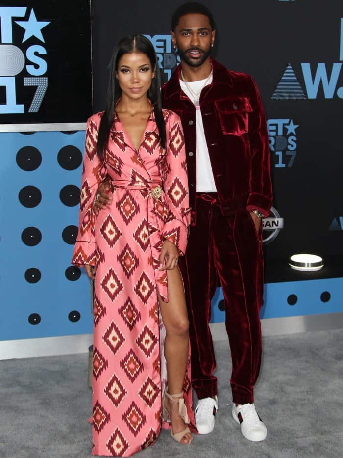 Jhene Aiko wearing a For Restless Sleepers robe dress with Schutz sandals and Big Sean wearing a Bally tracksuit, a Stella McCartney shirt, and Gucci shoes