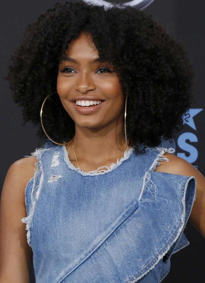 Yara Shahidi's dress features layered ruffles, flirty cut-out details, shredded denim, and an asymmetrical hem with worn edges