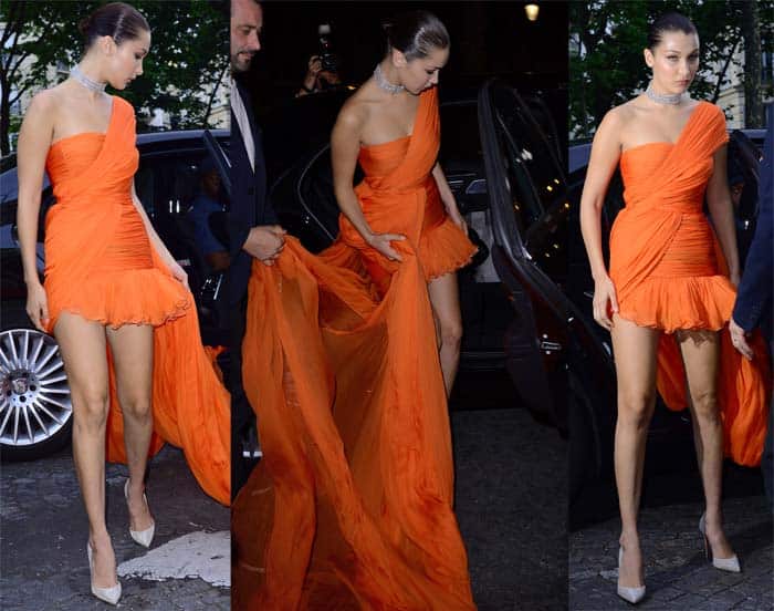 Bella Hadid stuns in an orange Giambattista Valli couture dress for the Vogue Party in Paris