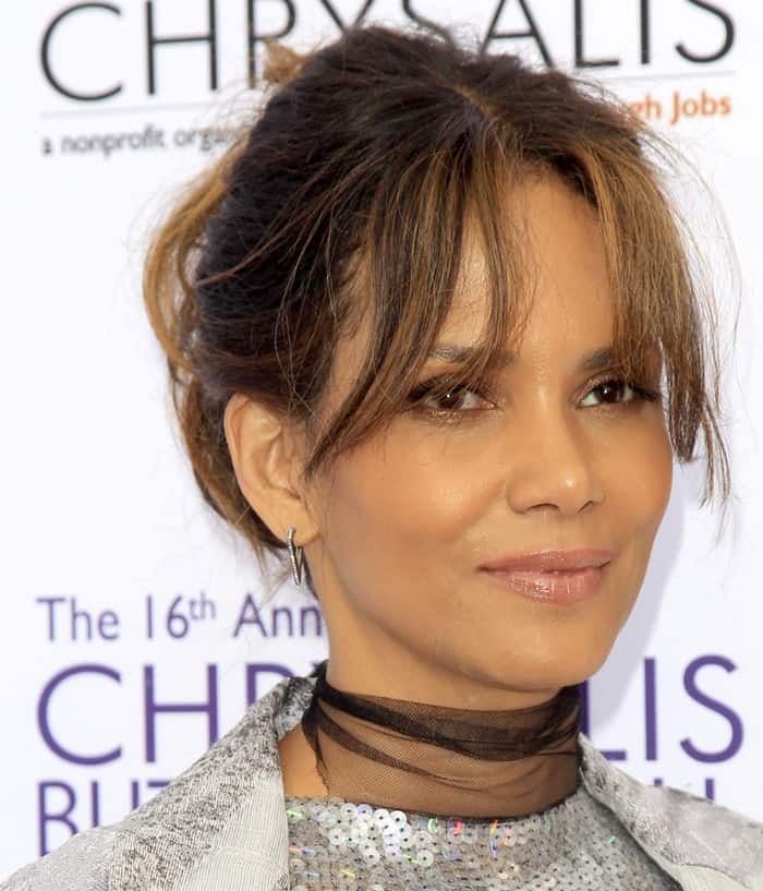 Halle Berry's hairstyle with bangs and Eva Fehren hoop earrings