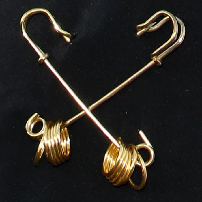 Close-up of Halle Berry's gold safety pin brooch
