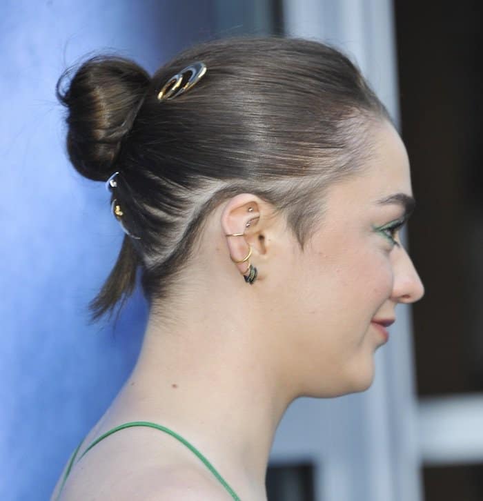 Maisie Williams styled her hair in a sleek, tight bun adorned with metal hair slides