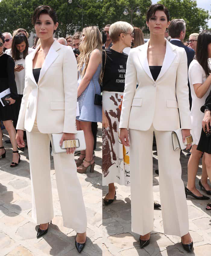 Gemma Arterton wearing a chic white suit ensemble at the Dior fashion show during Paris Fashion Week.
