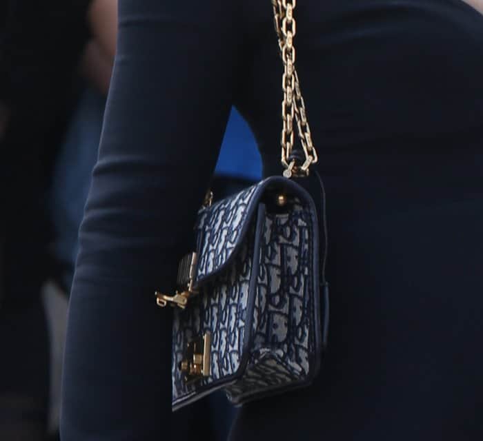 Natalie Portman styled her little black dress with a Dior monogram purse.