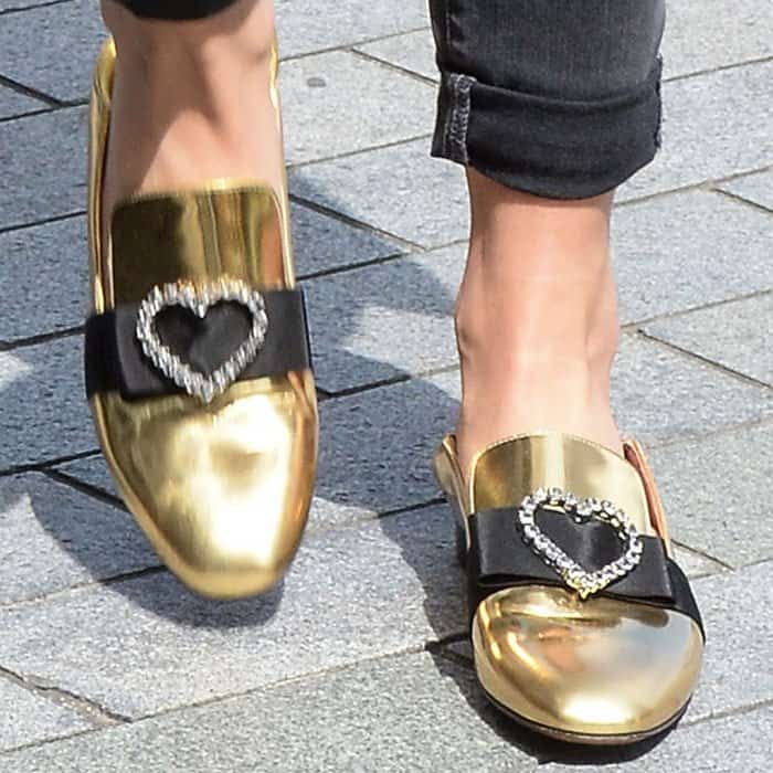 Rita puts the finishing touches on her look with a pair of Bally "Phylis" metallic leather slippers