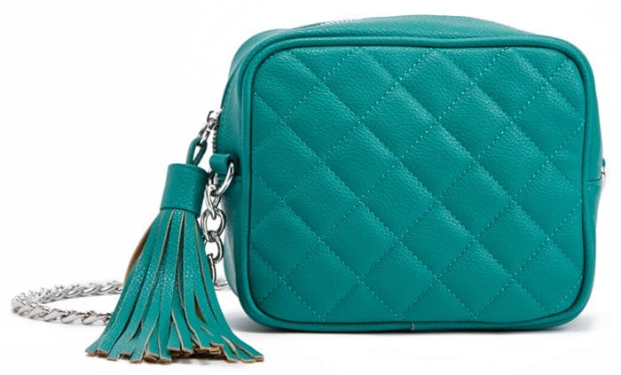 Green quilted crossbody bag with a tasseled zip-around closure and chain-drop shoulder strap