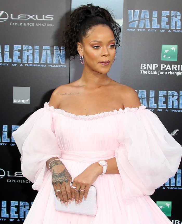 Rihanna exudes elegance in a soft pink, off-the-shoulder Giambattista Valli gown, pairing the voluminous tulle with delicate jewelry and a sparkling clutch