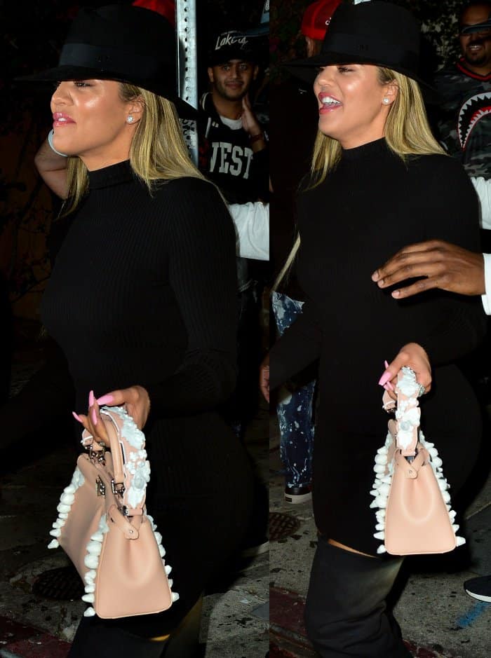 Khloé Kardashian wearing a Naked Wardrobe dress, a Maison Michel fedora, and black slouchy over-the-knee boots