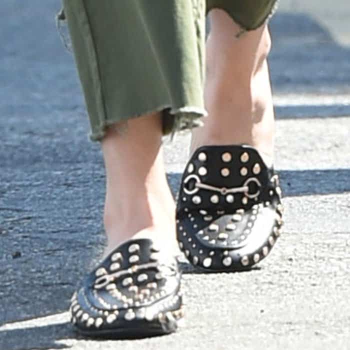 Bella stylishly finished her outfit with a pair of Gucci "Princetown" studded mules