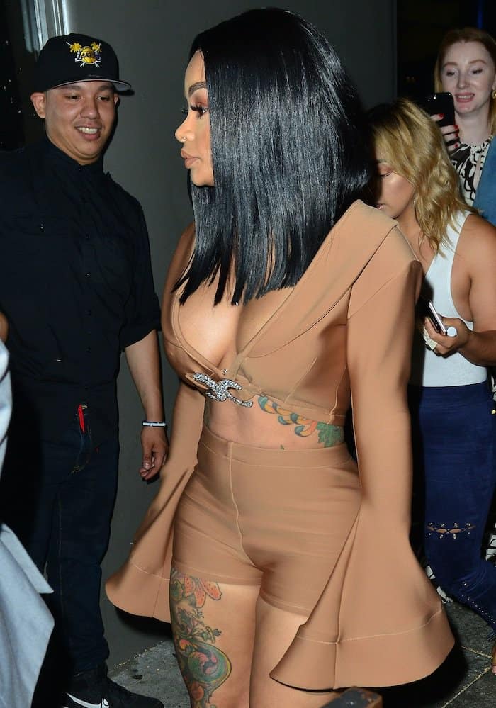Blac Chyna flaunted her ample cleavage and her small waist in a nude crop top with long bell sleeves