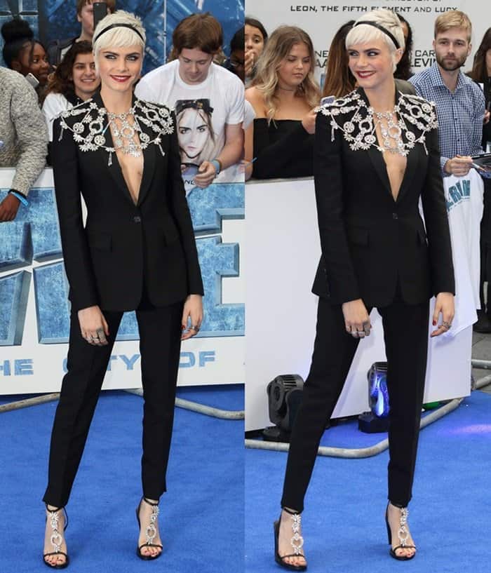 Recreate Cara Delevingne's striking premiere look with a tailored black blazer and pantsuit, statement crystal jewelry, and embellished strappy sandals for an edgy yet glamorous vibe
