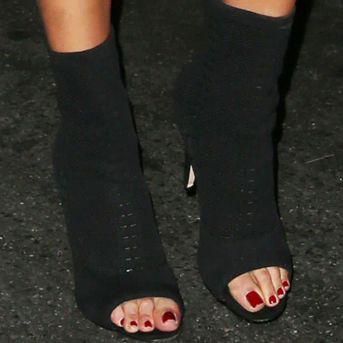 Olivia Culpo displays her pedicured toes in knitted sock boots