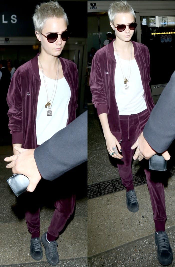 Cara Delevingne wearing a Puma T7 velour tracksuit and Fenty Puma by Rihanna grey velvet lace-up creepers at LAX