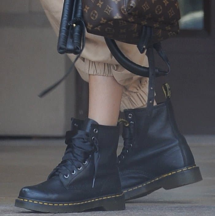 Madison Beer wearing Dr. Martens 1460 Boots and Louis Vuitton Palm