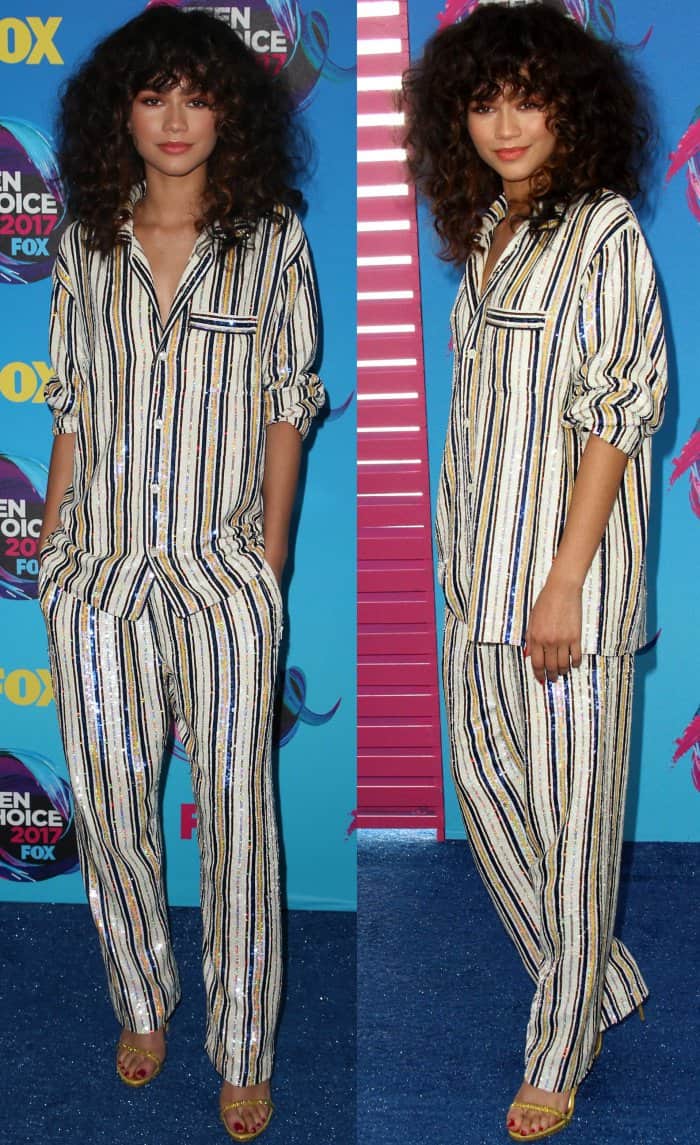 Zendaya with curly hair and bangs in a classic pajama set