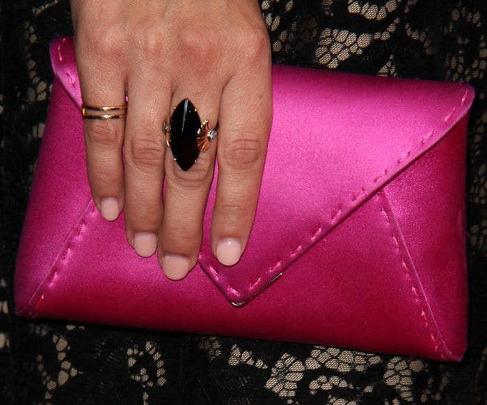 The actress mismatches with a silk Tyler Ellis clutch