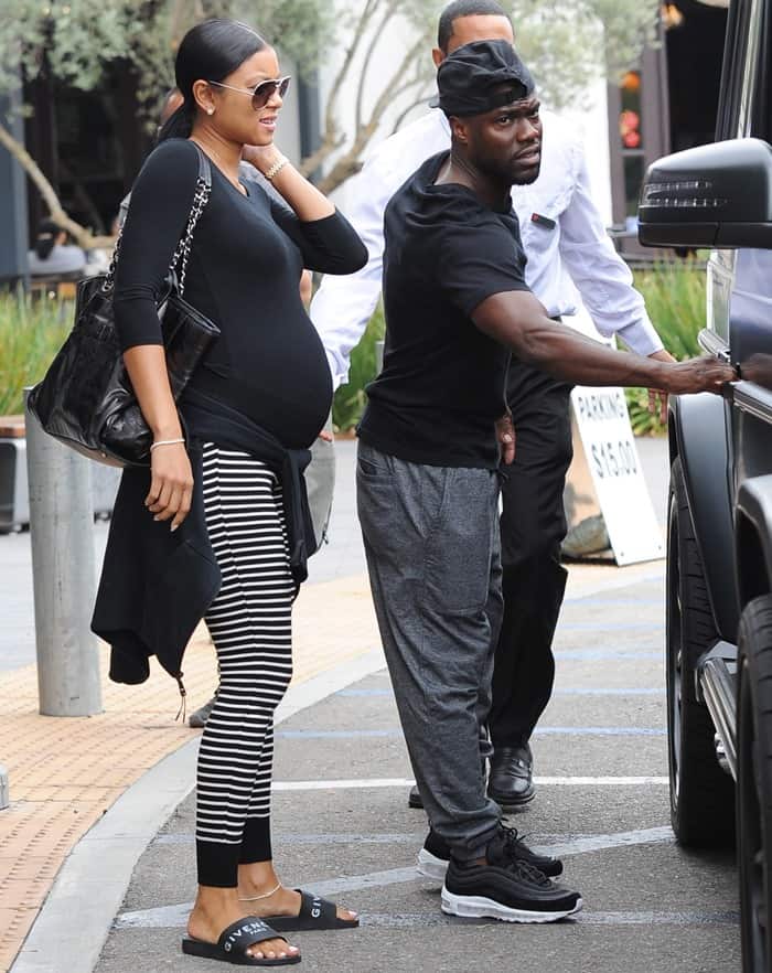 Eniko Hart's cheating husband, Kevin Hart, in a T-shirt, grey sweatpants, black and white sneakers, and a black cap
