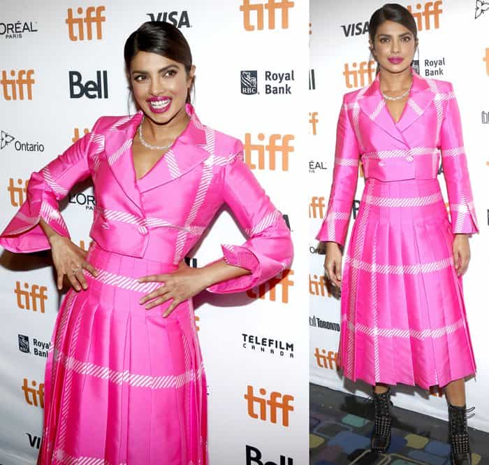 Priyanka Chopra in a pink cropped blazer with a matching midi skirt and studded ankle booties