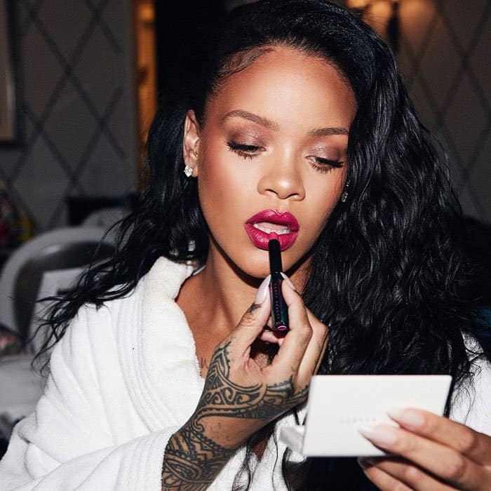 Rihanna uploads a photo of herself putting on Fenty Beauty makeup before the launch