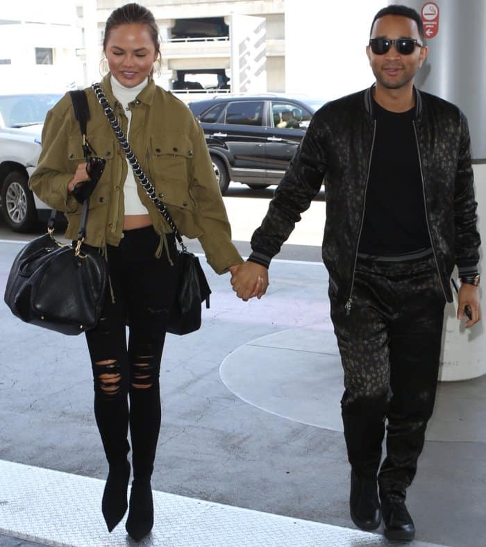 Chrissy Teigen and John Legend walking hand-in-hand at LAX