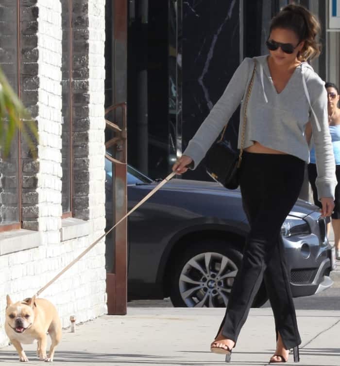 Chrissy Teigen wearing an A.L.C. ensemble and black ankle-strap sandals with clear heels while out and about in LA