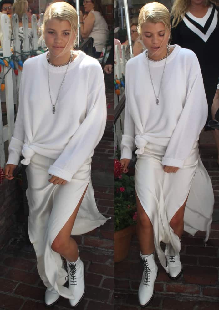 Sofia Richie wearing an all-white ensemble styled with The Row "Fara" lace-up leather combat boots 