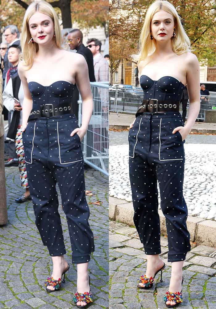 Elle towered in an embellished navy blue jumpsuit