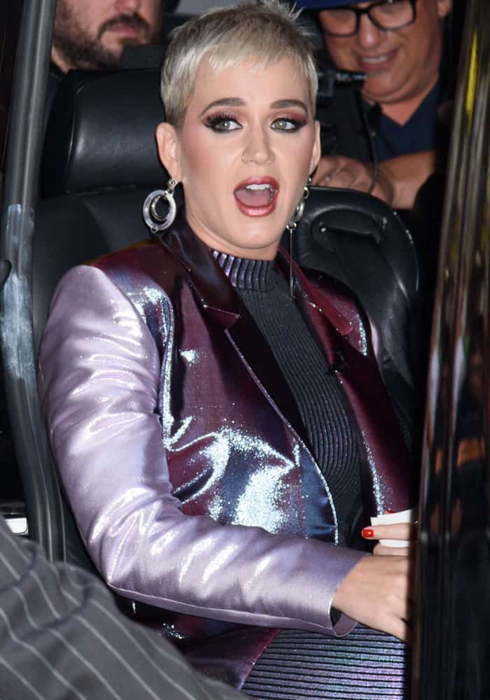 Katy shows off her platinum pixie cut with her high-shine outfit