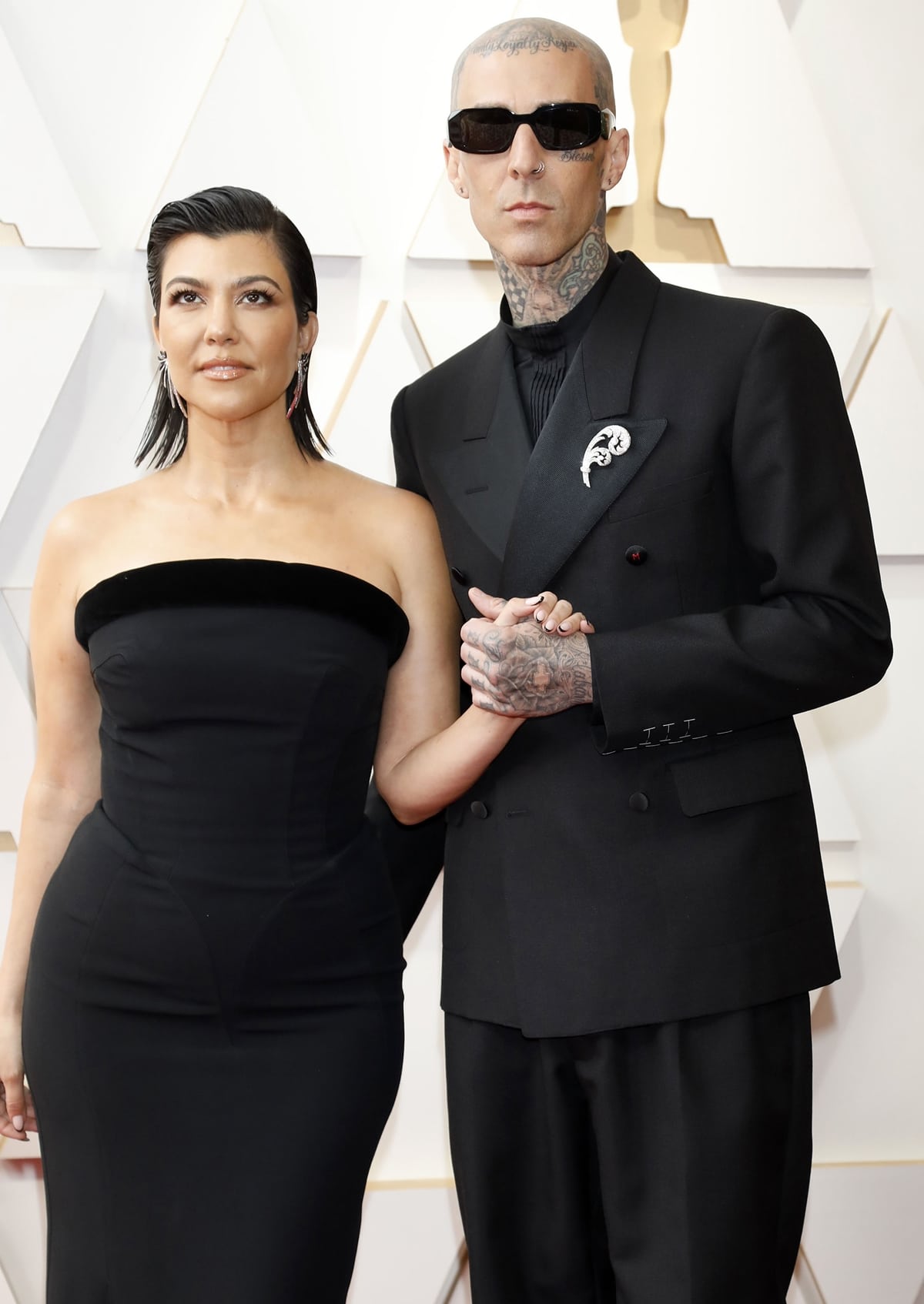 Kourtney Kardashian wore jewelry by Lorraine Schwartz for her very first Oscars with fiancé Travis Barker in a black suit by Maison Margiela