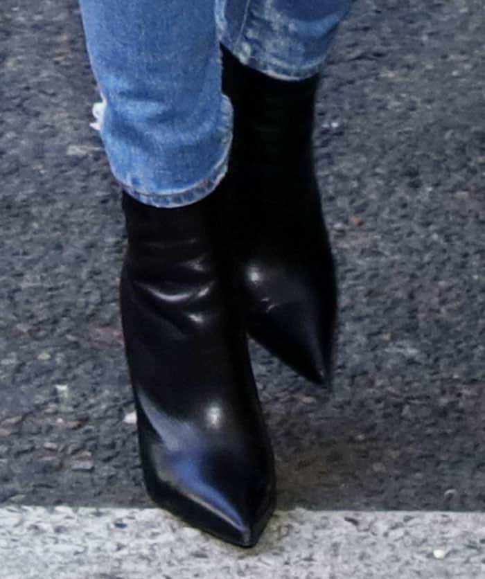 Kourtney wears her Balenciaga "Knife" boots several times during the trip