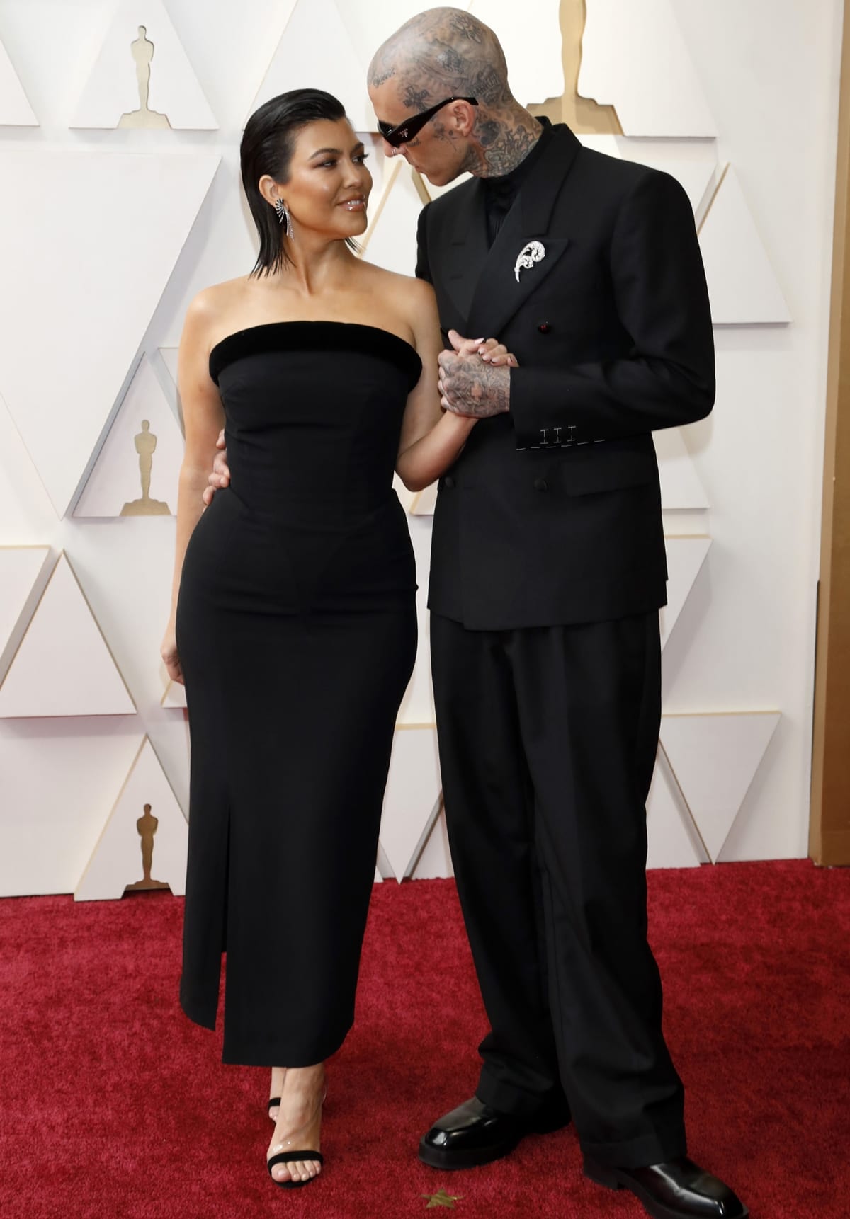 Kourtney Kardashian in a Mugler dress and Aquazzura shoes and Travis Barker in a Maison Margiela suit at the 94th Annual Academy Awards