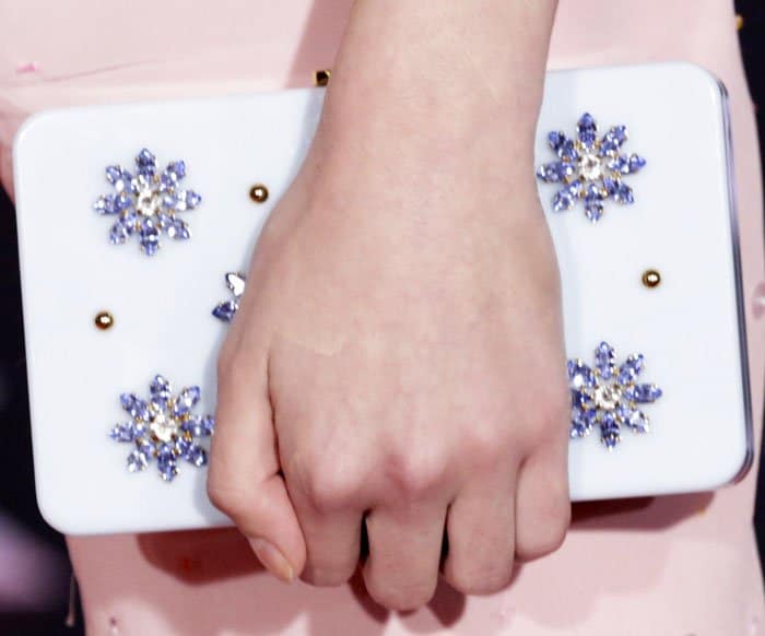 Mackenzie departs slightly from her Miu Miu look with a jewel-embellished Prada clutch