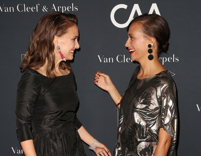 Natalie Portman’s bright pink beaded drop earrings bring a bold pop of color to her classic black Dior dress, while Rashida Jones opts for dramatic black tiered pompom earrings that perfectly complement the metallic print of her flowy gown
