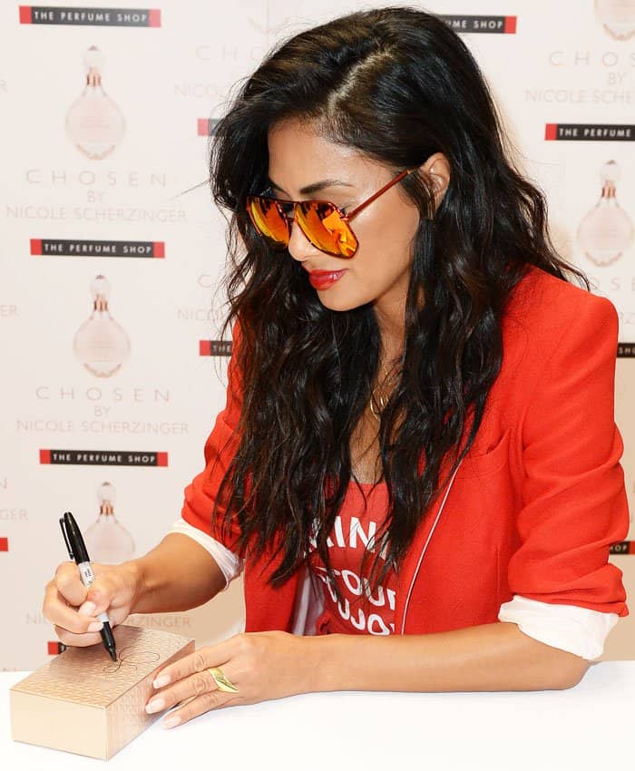 The pop star signs boxes of her new fragrance "Chosen"