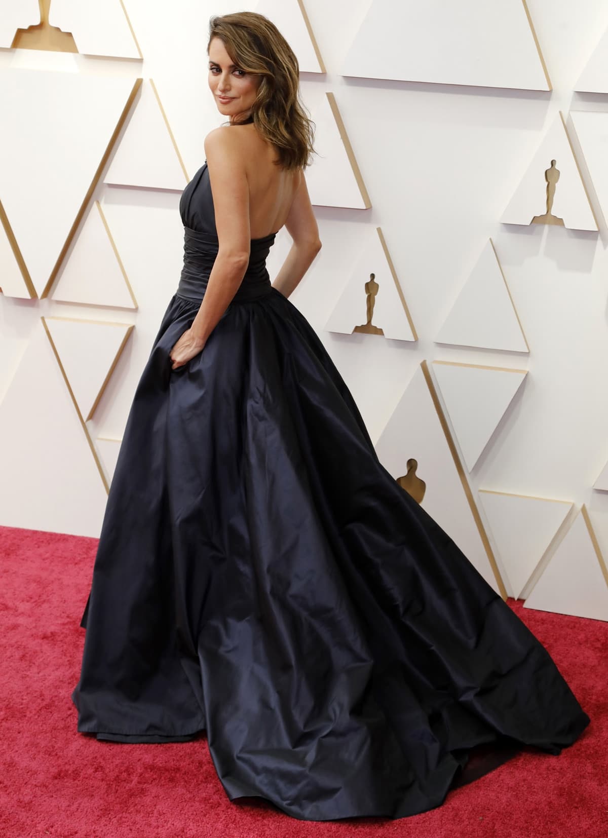 Penélope Cruz in a custom black and silver Chanel Couture halter gown with 8,000 embroidered pieces that took 680 hours to make