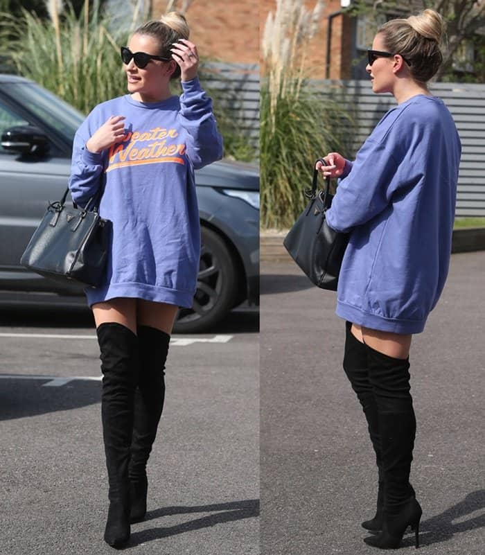 Georgia Kousoulou effortlessly combines cozy and chic in an oversized 'Sweater Weather' sweatshirt paired with thigh-high black boots and a classic Prada handbag