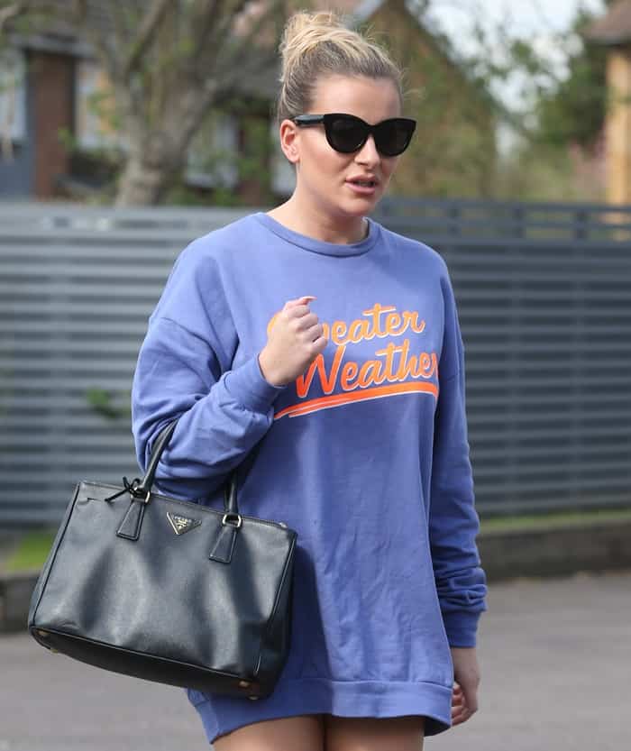 Georgia Kousoulou rocks a relaxed 'Sweater Weather' sweatshirt with a chic Prada handbag, perfect for a cozy yet stylish fall look
