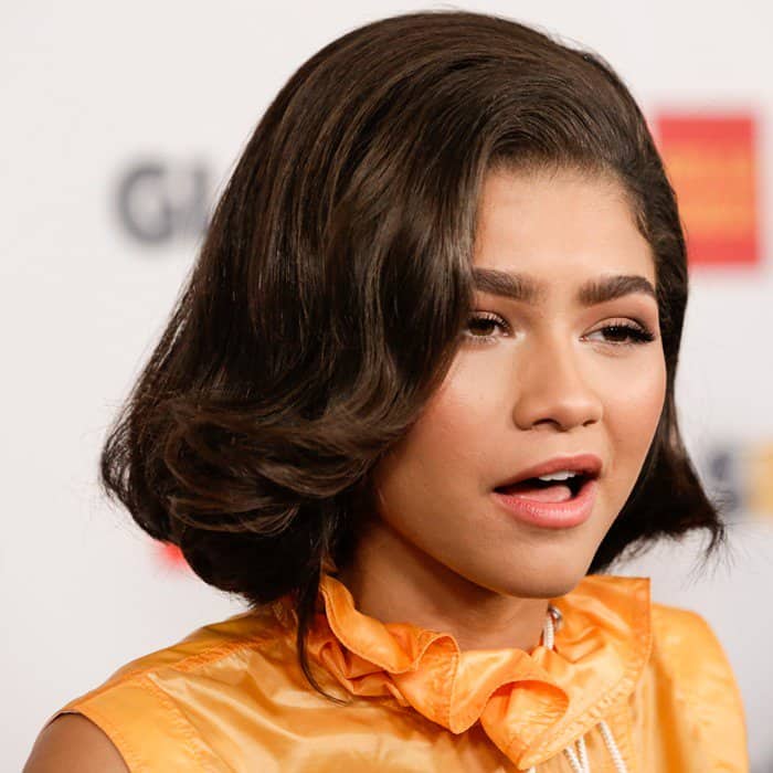 Zendaya with her hair styled into side-swept waves