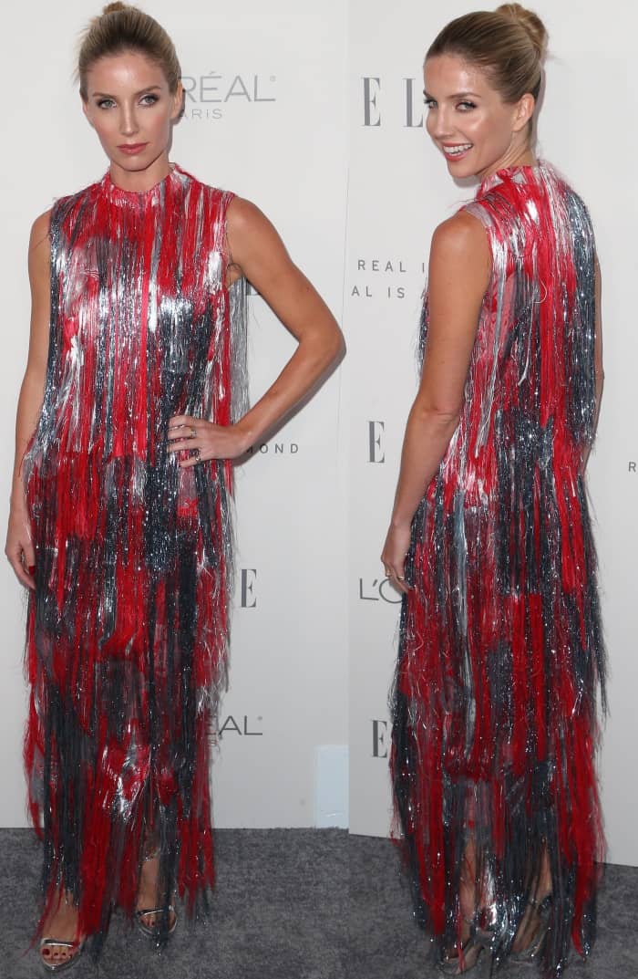 Annabelle Wallis turned heads in a bold Erdem dress adorned with red, silver, and black fringe, creating a striking, textured look