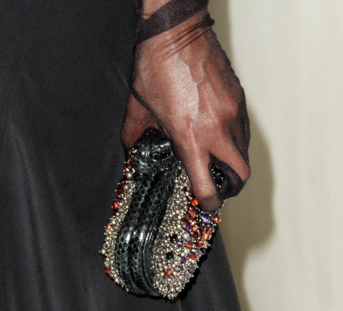 Tessa Thompson accessorizes her dramatic look with sheer black gloves and a stunningly intricate, crystal-embellished Bottega Veneta clutch
