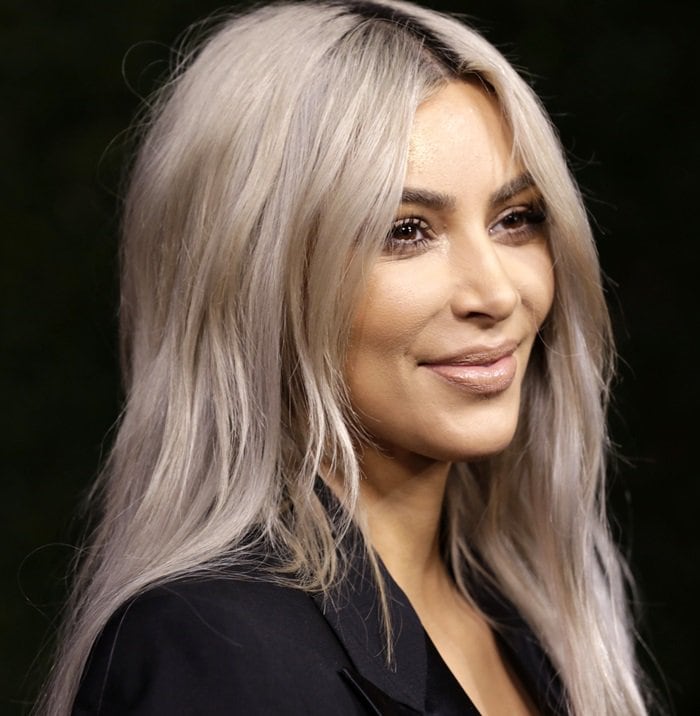 Kim Kardashian showcases her platinum blonde look in a chic black tuxedo