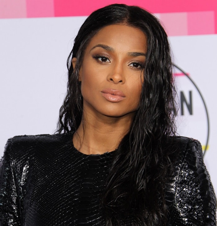 Ciara e flawlessly complemented her attire with a sleek center-parted wet hairstyle, cascading into playful curls, and smoky eyes that added an extra touch of allure, all balanced with a natural lip