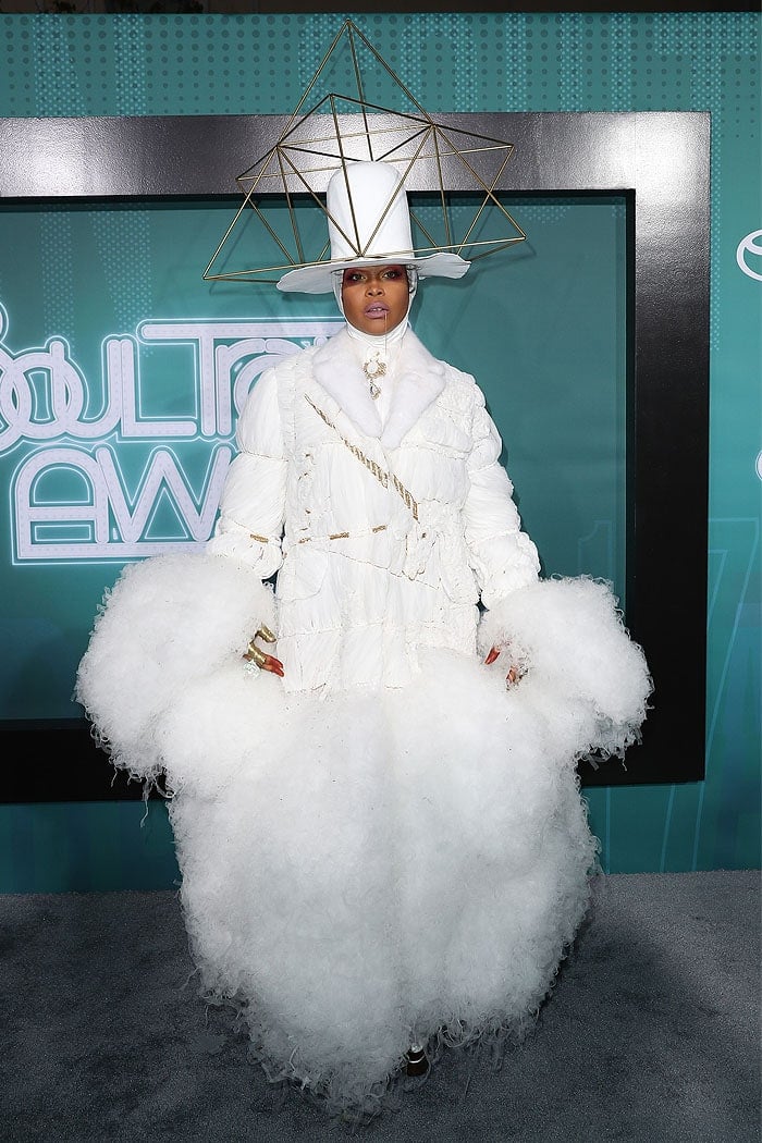 Erykah Badu donned a tissue-like white blazer that had gold rope ties and poofy white tulle clouds erupting from the wrists and hemline