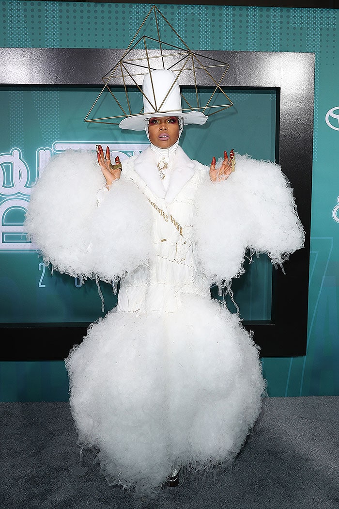 Erykah Badu finished her avant garde ensemble with a metal chain dangling from her mouth and odd gold-and-rust paint stains on her fingertips